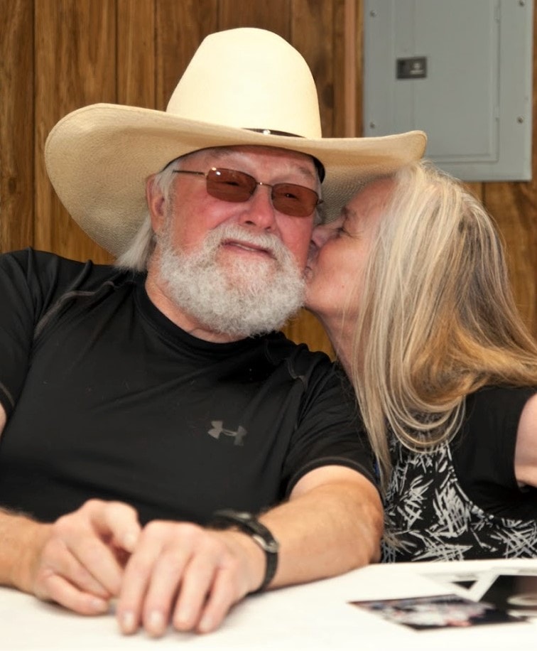 Dr. debi Story Maddox thanking Charlie Daniels for headlining a music festival organized and promoted by Michael