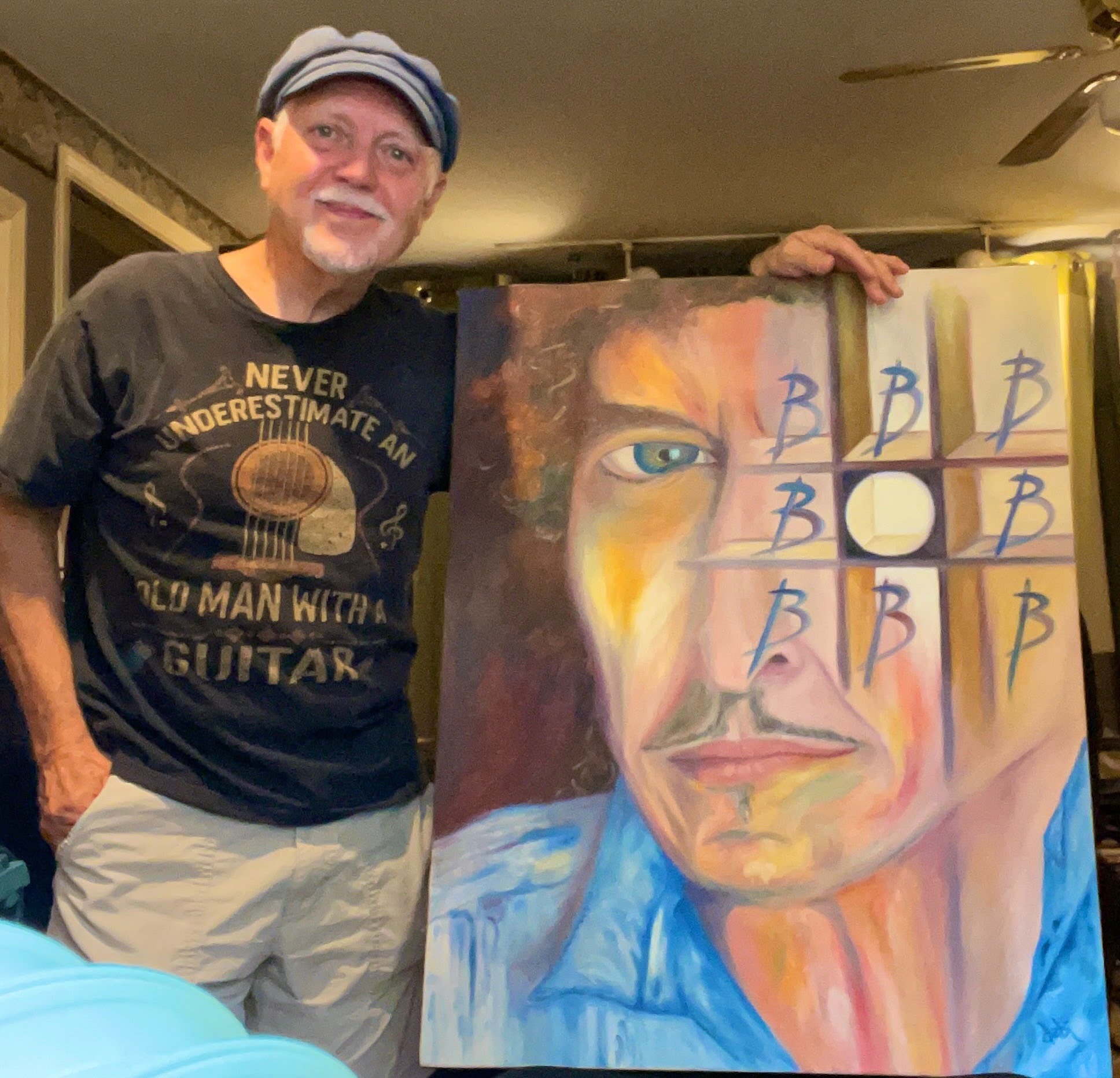 Phil Keaggy holding debi Story Maddox's Bob Dylan painting