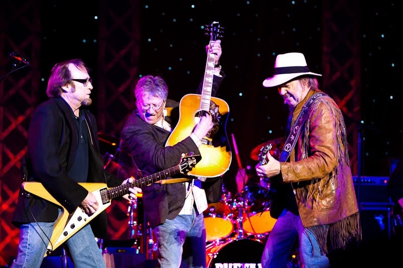 Richie Furay performing on stage with guitar